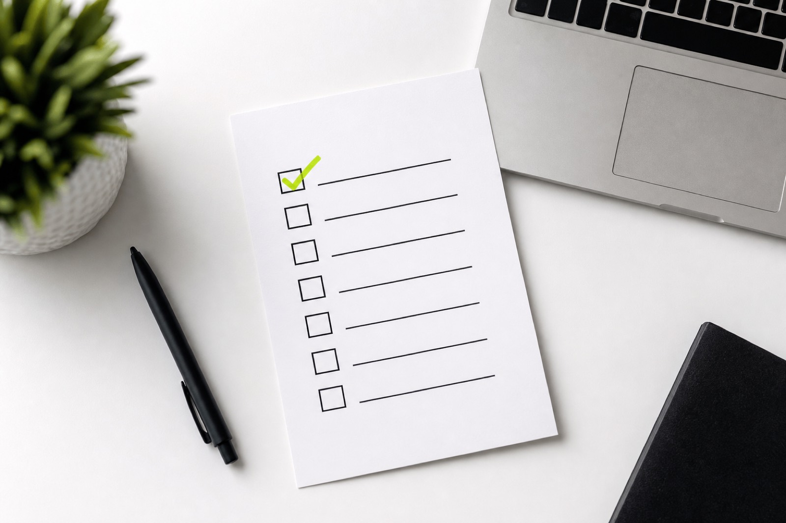 Checklist and sticky notes on a creator workspace desk